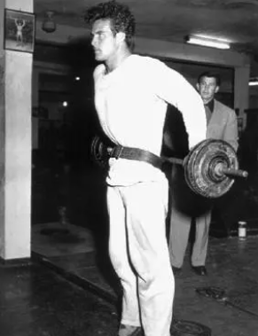 Steve Reeves wearing a weightlifting belt